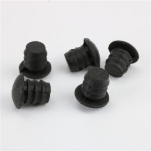 Five black ribbed plugs with round flange heads