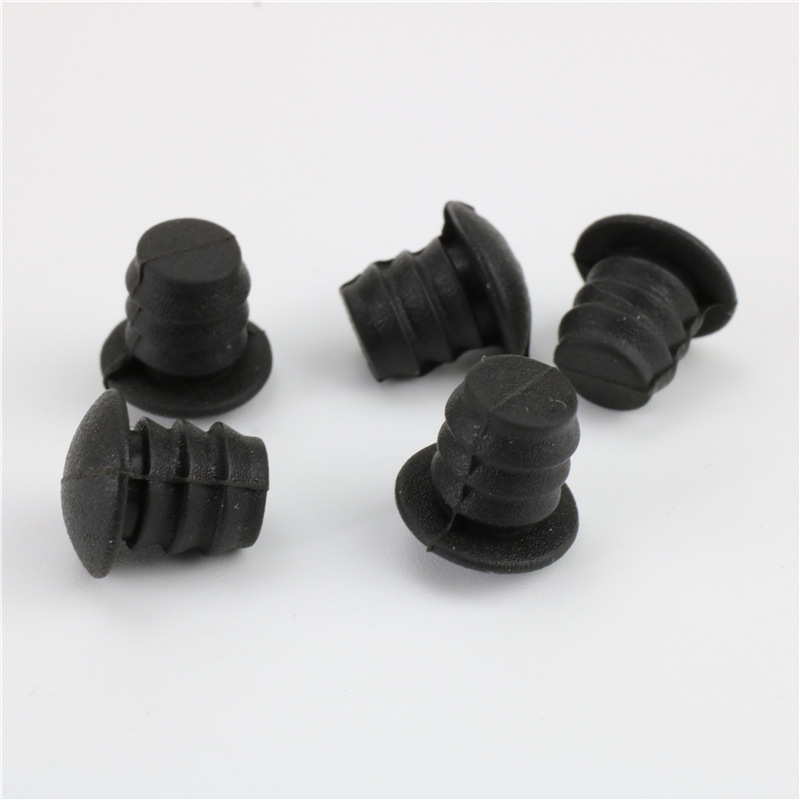 Five black ribbed plugs with round flange heads