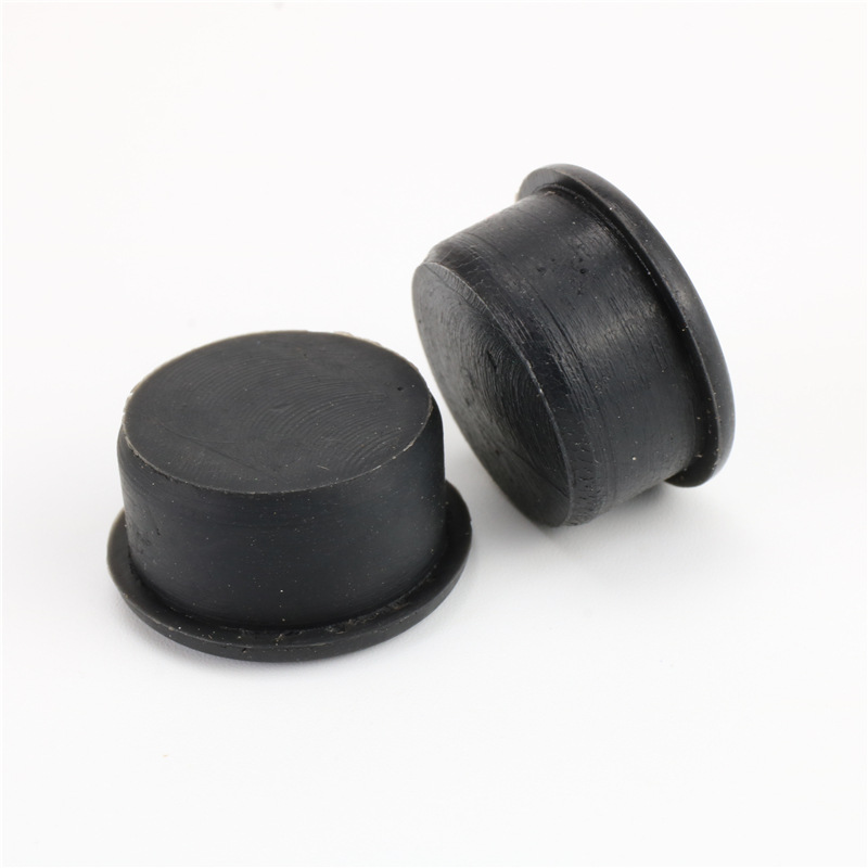 Two black round plugs with flange heads