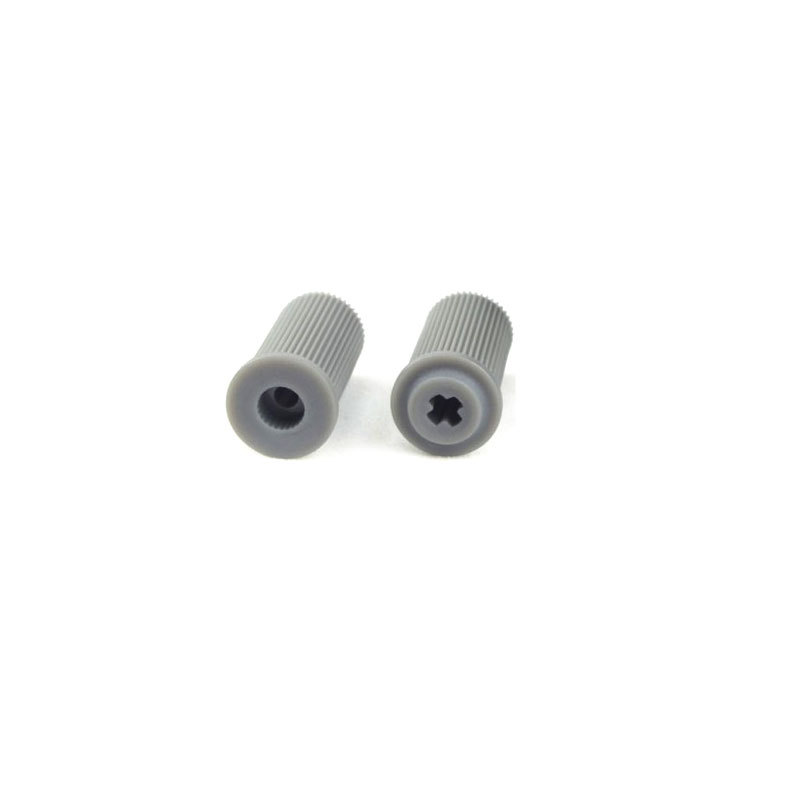 Two grey cylindrical hub adapters for an omnidirectional robot wheel
