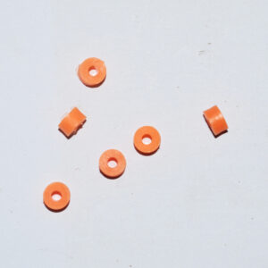Orange ring-shaped bushings on a pale background