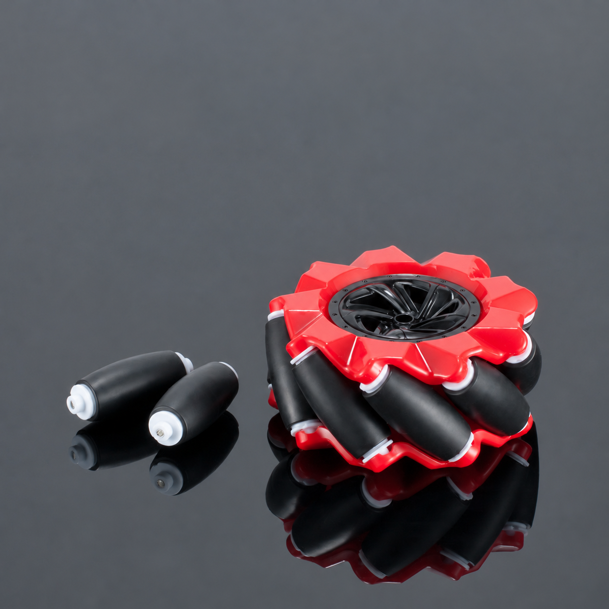 Red Mecanum robot wheel with two loose black rubber rollers