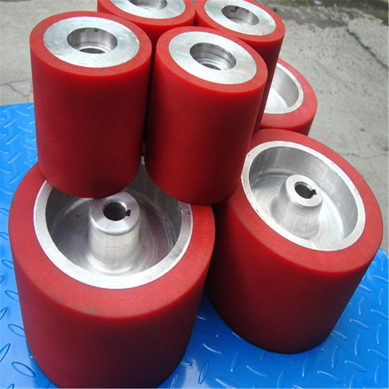 Red rubber-coated rollers with metal shafts