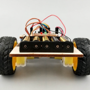Robot chassis with black rubber wheels, yellow gearmotors and a battery holder