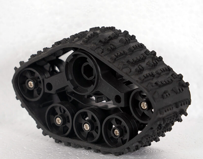 Angled reverse view of a black robot tank track and central drive hub