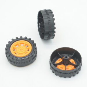 Three black treaded robot wheels with orange hubs showing front and rear views