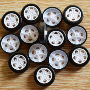 Assorted small black wheels with white spoked plastic hubs