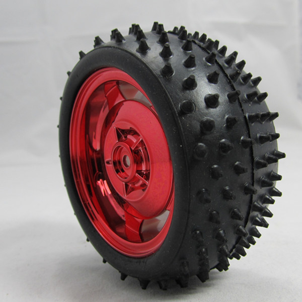 Studded black rubber tyre with a red wheel hub