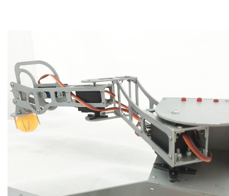 Side view of a metal teaching robot arm holding a yellow ball