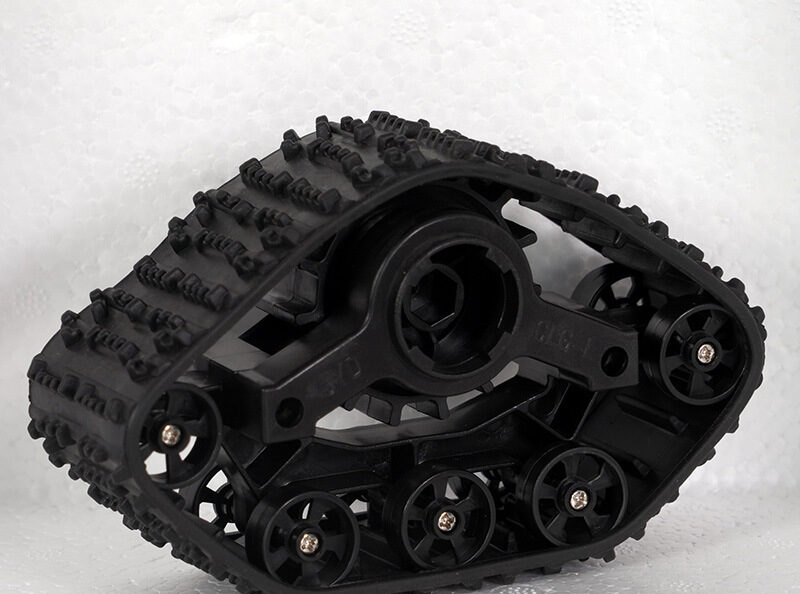 Reverse view of a triangular robot track showing wheel screws and drive hub